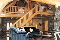 Looking at log stairs and sleeping loft from greatroom