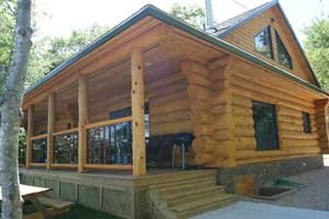 Exterior of log house with covered porch