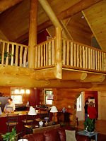 view of loft with log railing
